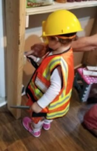 Child pretending to be a construction worker