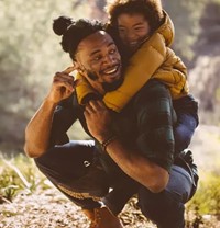 Dad giving child piggyback ride